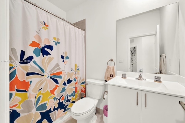 bathroom featuring vanity, toilet, and a shower with shower curtain