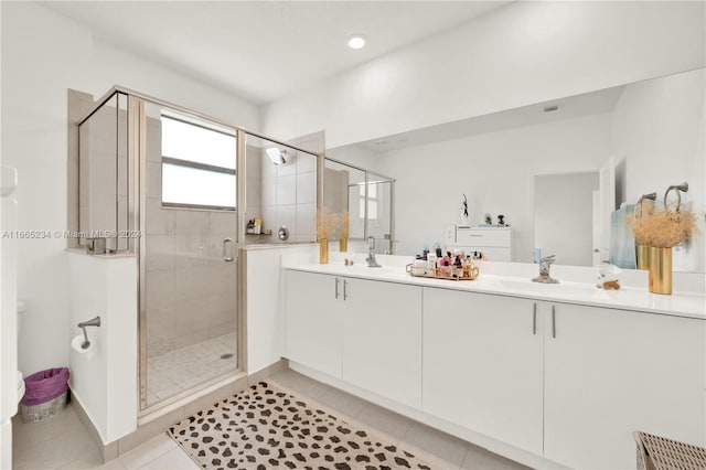 bathroom with vanity, tile patterned flooring, and a shower with shower door