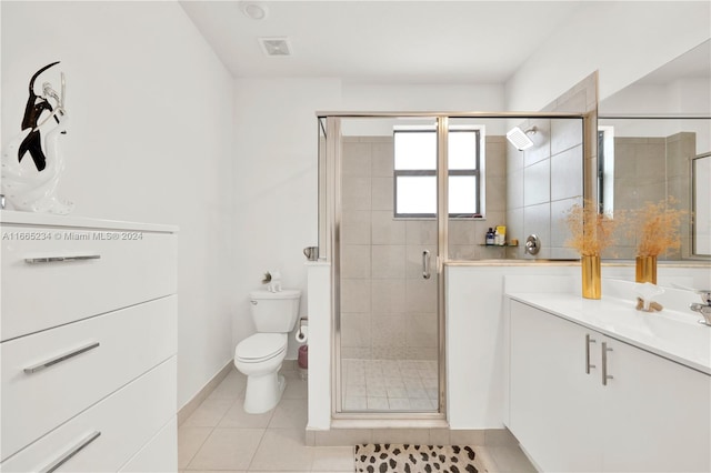 bathroom featuring vanity, a shower with shower door, toilet, and tile patterned flooring