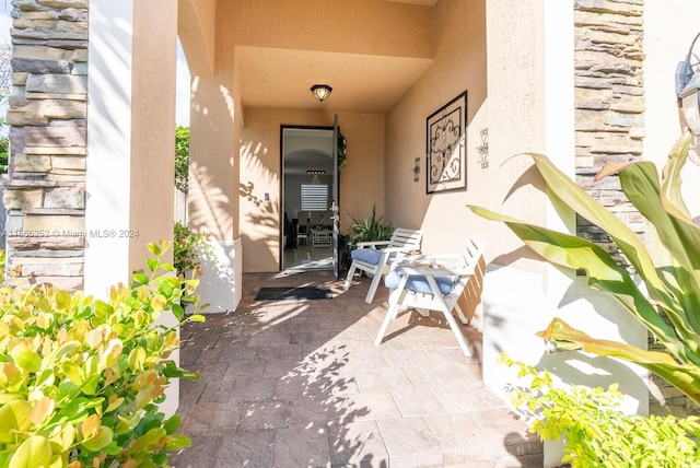 property entrance featuring a patio area