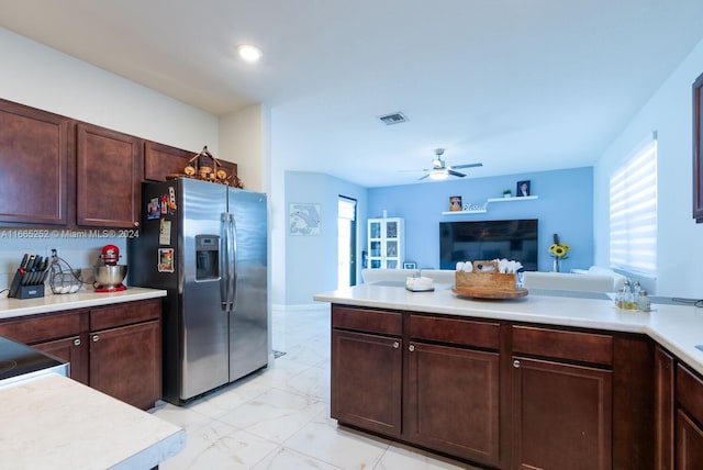 kitchen featuring dark brown cabinets, ceiling fan, and stainless steel fridge with ice dispenser