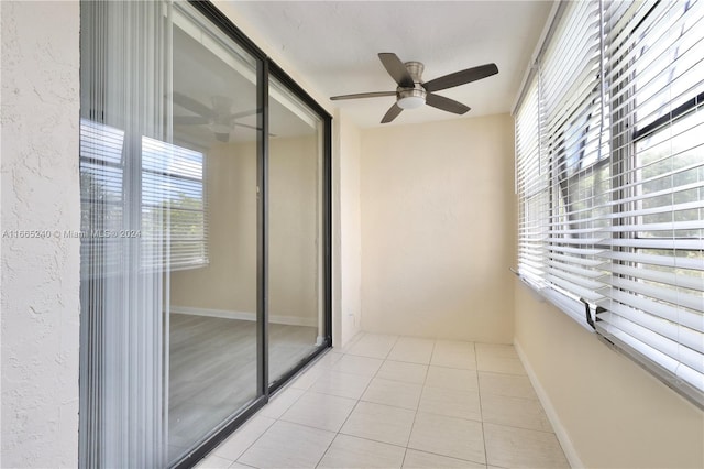 interior space with light tile patterned floors, ceiling fan, and plenty of natural light