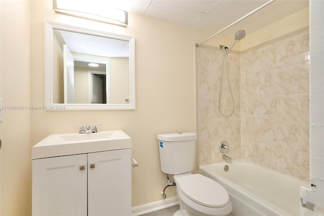 full bathroom featuring tiled shower / bath combo, vanity, and toilet