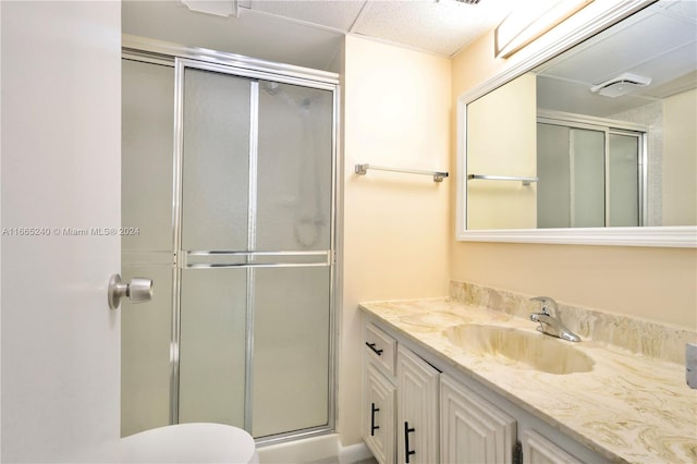 bathroom featuring vanity, toilet, and an enclosed shower