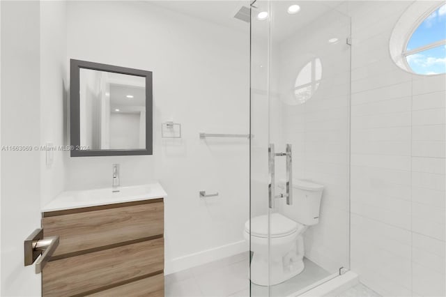 bathroom with tile patterned floors, a shower with door, vanity, and toilet