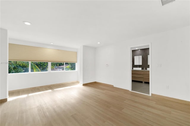 empty room with light hardwood / wood-style flooring