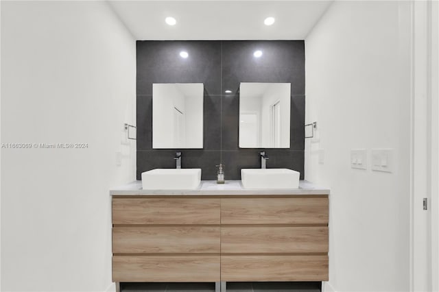 1769 Wa Kee Na Dr, Miami, FL 33133 - bathroom with recessed lighting, double vanity, tile walls, and a sink