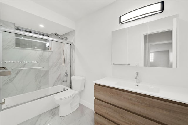 full bathroom featuring vanity, toilet, and bath / shower combo with glass door