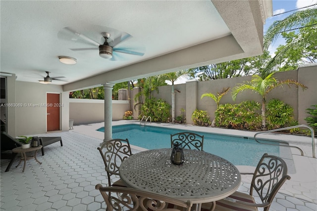 view of swimming pool featuring ceiling fan and a patio