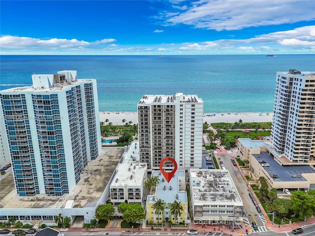 aerial view featuring a water view and a beach view