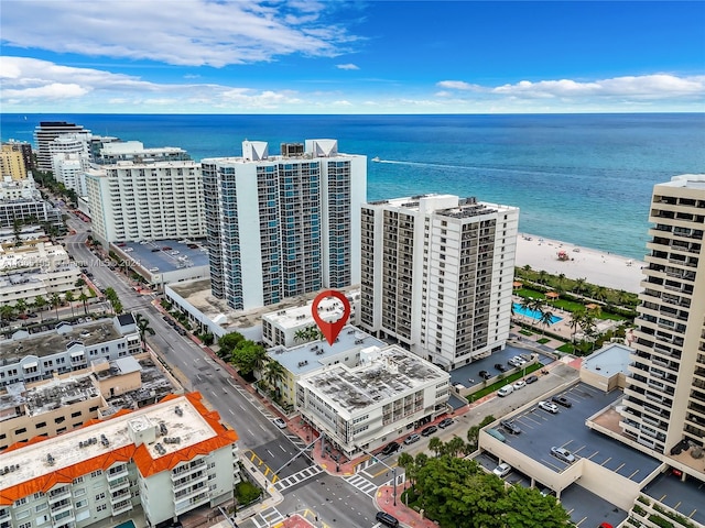 drone / aerial view featuring a water view and a view of the beach