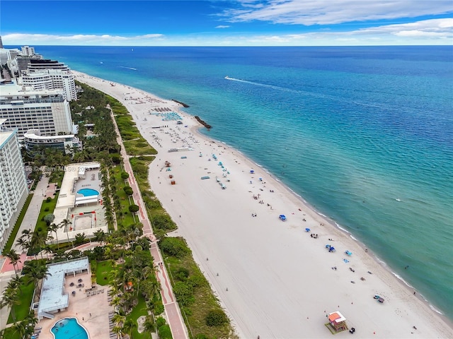 aerial view with a water view and a beach view