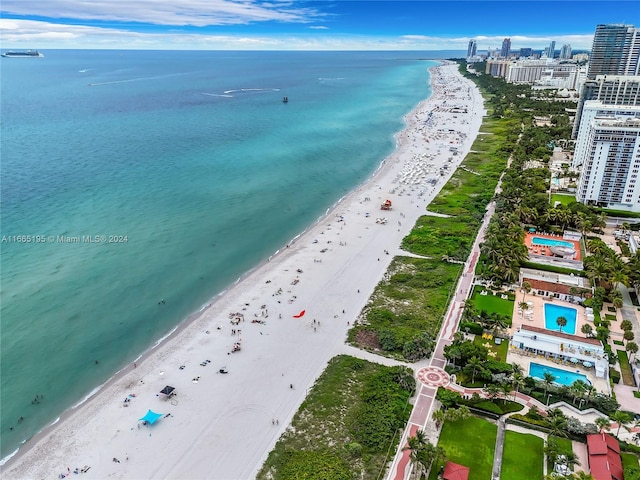 bird's eye view featuring a view of the beach and a water view