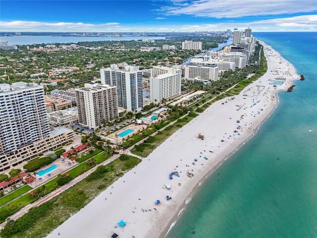 bird's eye view featuring a water view and a beach view