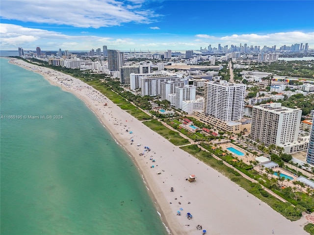 bird's eye view with a water view and a beach view