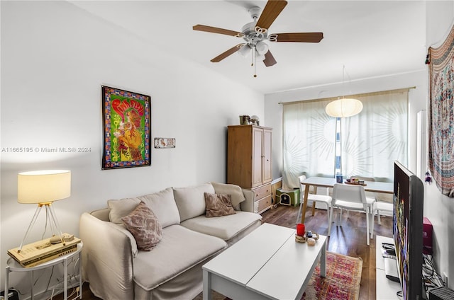 living room with ceiling fan and dark hardwood / wood-style flooring