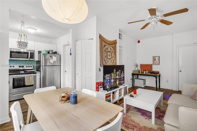 dining area featuring dark hardwood / wood-style flooring and ceiling fan