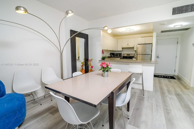 dining space featuring light hardwood / wood-style flooring