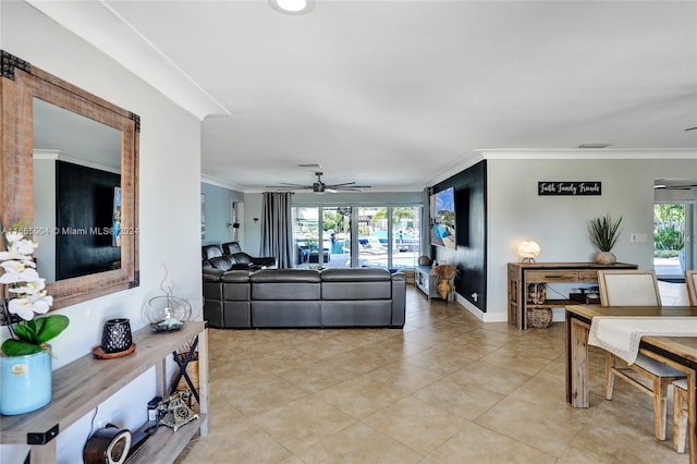 tiled living room featuring ceiling fan, plenty of natural light, and crown molding