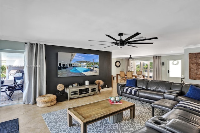 living room featuring ornamental molding, ceiling fan, and light tile patterned floors