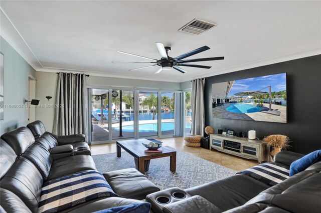 living room with ornamental molding, light tile patterned flooring, and ceiling fan