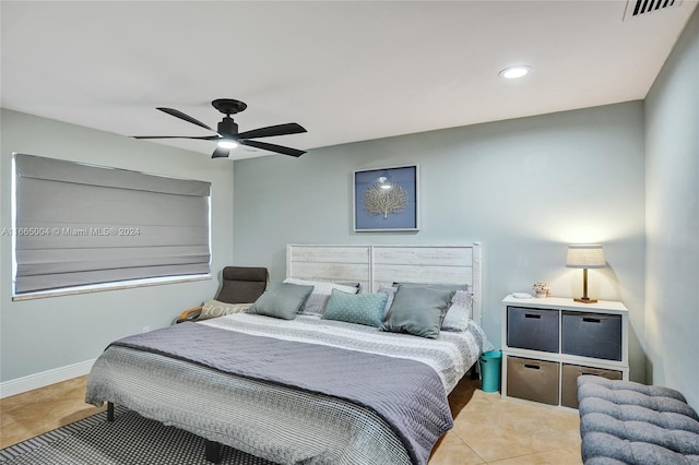 bedroom with ceiling fan and light tile patterned floors