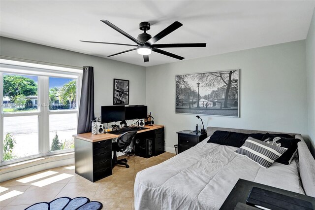 bedroom featuring light tile patterned floors, multiple windows, and ceiling fan