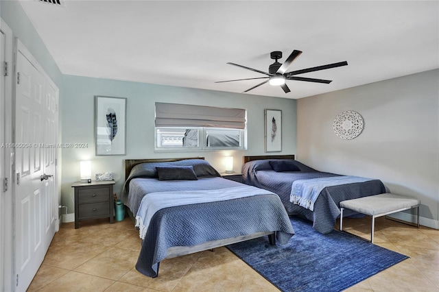 bedroom with ceiling fan and light tile patterned flooring