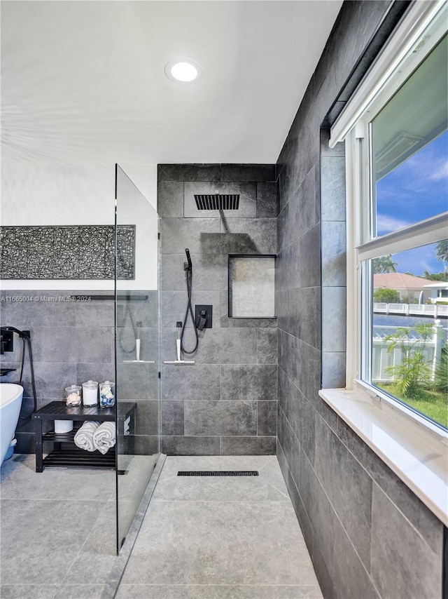 bathroom with separate shower and tub and tile patterned flooring