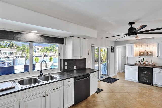 kitchen featuring white cabinets, beverage cooler, ceiling fan, stainless steel dishwasher, and sink