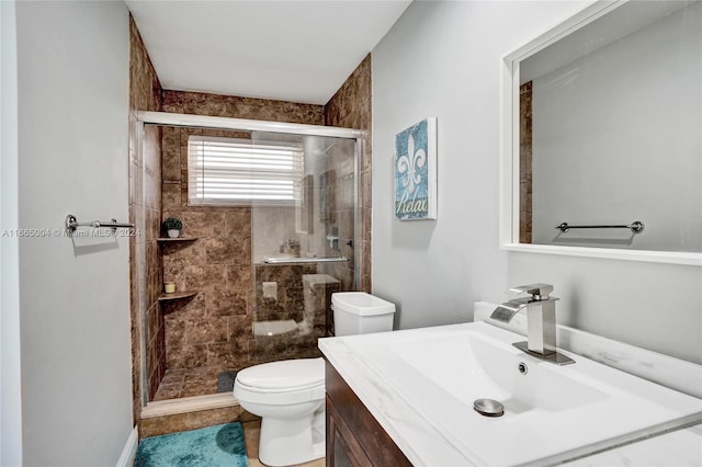 bathroom with tile patterned floors, walk in shower, vanity, and toilet