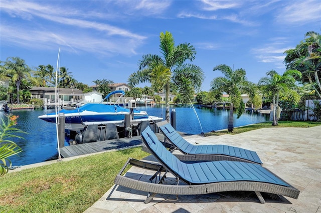 dock area with a lawn and a water view