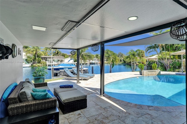 view of pool featuring a water view and a patio area