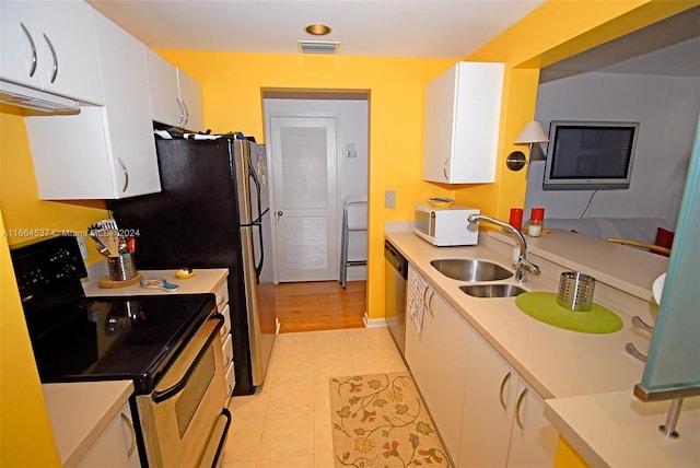 kitchen with white cabinets, sink, light tile patterned floors, dishwasher, and electric stove