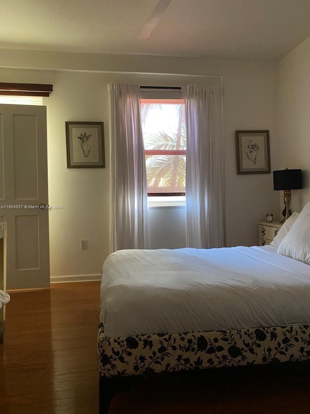 bedroom with ceiling fan and dark hardwood / wood-style flooring