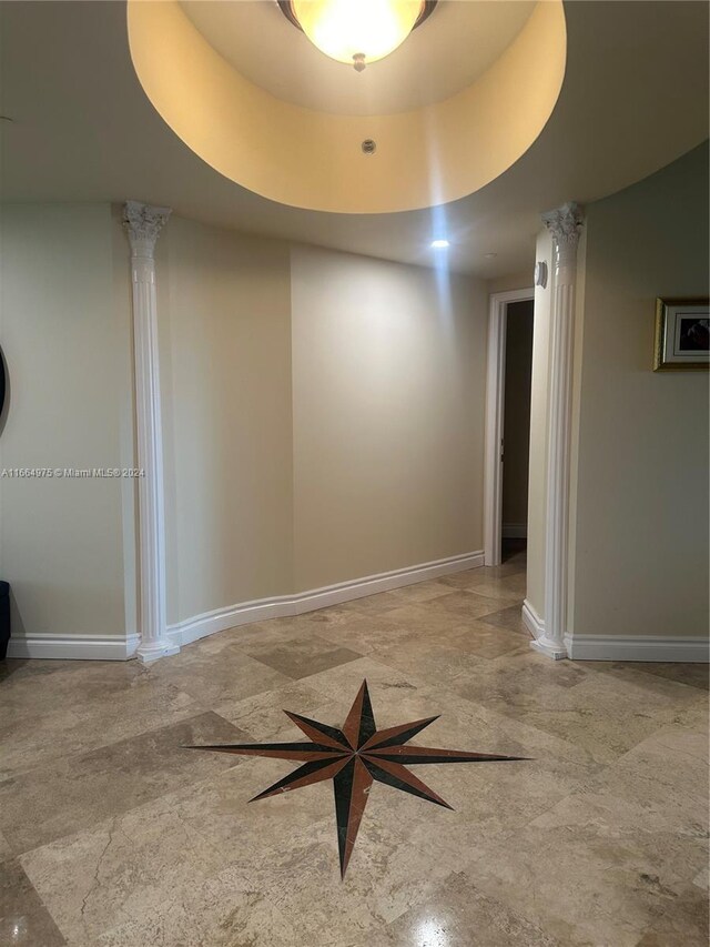 unfurnished room featuring a tray ceiling