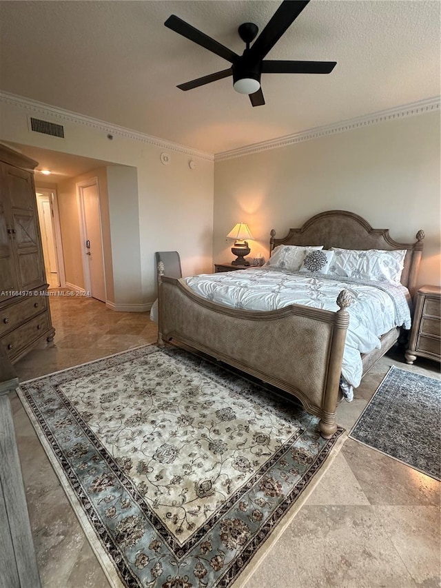 bedroom with ceiling fan, ornamental molding, and a textured ceiling