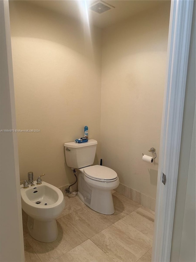 bathroom with toilet and a bidet