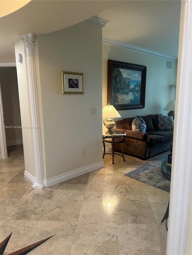 living room with ornate columns and ornamental molding