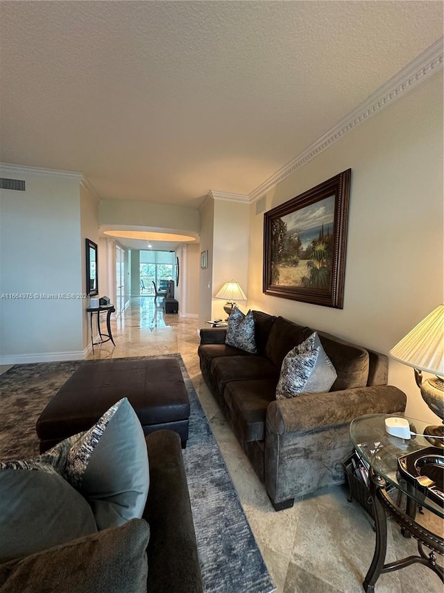 living room with ornamental molding and a textured ceiling