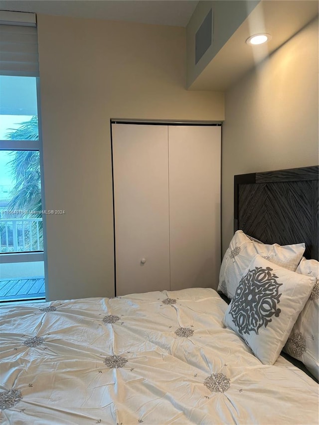 bedroom featuring multiple windows and a closet