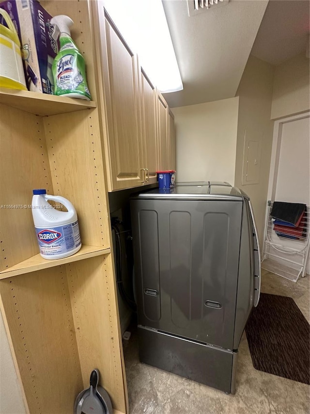 laundry area with cabinets and washer / dryer