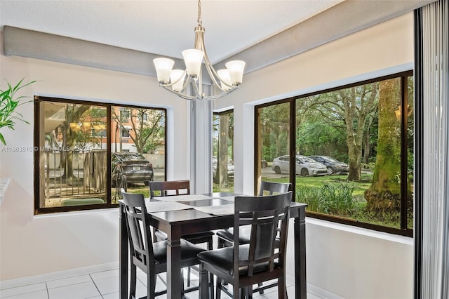 dining space featuring light tile patterned flooring, a chandelier, and a healthy amount of sunlight