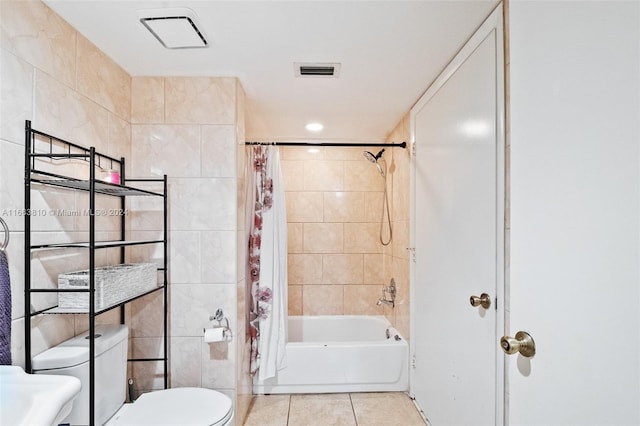 bathroom featuring tile patterned flooring, tile walls, shower / bath combo, and toilet