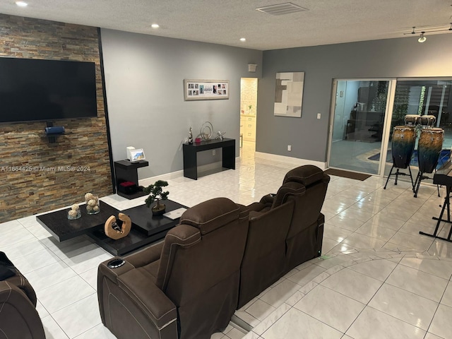 living room featuring a textured ceiling and light tile patterned floors