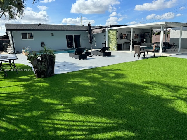 rear view of house featuring a patio and a lawn