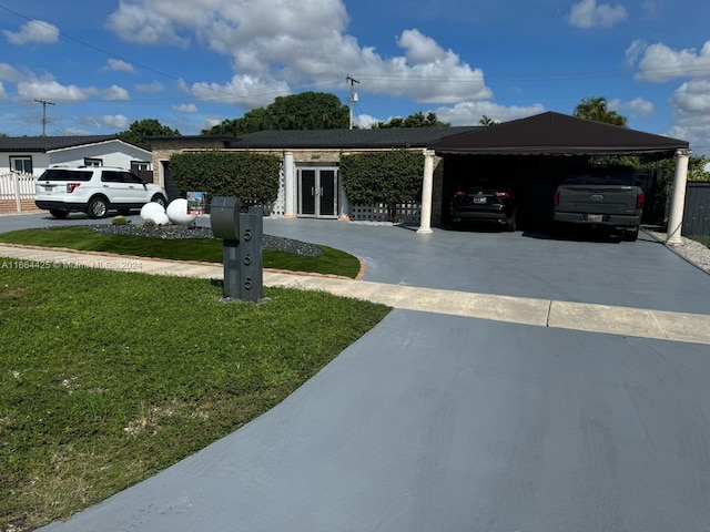 view of front of home with a front lawn and a carport