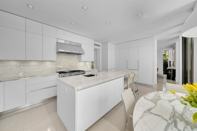 5327 N Bay Rd, Miami Beach, FL 33140 - kitchen featuring wall chimney range hood, a sink, modern cabinets, and recessed lighting