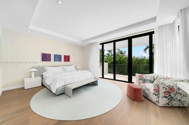 5327 N Bay Rd, Miami Beach, FL 33140 - bedroom featuring a raised ceiling, access to outside, wood finished floors, recessed lighting, and baseboards