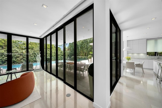 5327 N Bay Rd, Miami Beach, FL 33140 - entryway with light tile patterned flooring, a wall of windows, and french doors